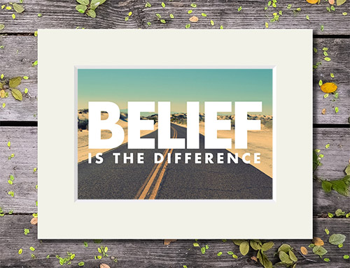 Sun-drenched desert road with 'Belief is the Difference' quote