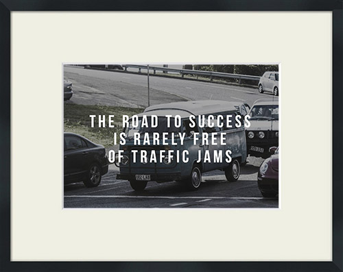 Traffic jam with 'The Road To Success Is Rarely Free of Traffic Jams' quote