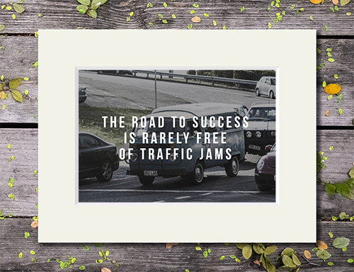 Traffic jam with 'The Road To Success Is Rarely Free of Traffic Jams' quote